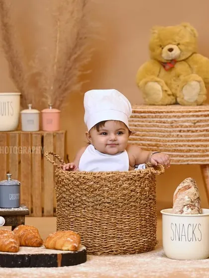 A cute 'little chef' themed baby shoot, with the baby in a chef's hat sitting in a basket.