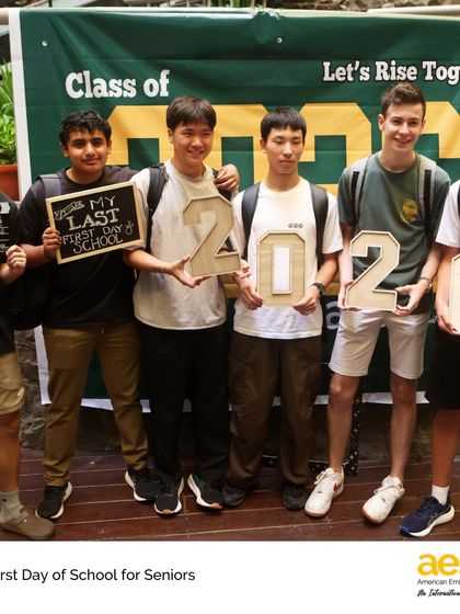 A group of senior boys proudly holds signs for their 'Last First Day of School'. It's a bittersweet moment that we celebrate as a community, honoring their achievements and the path ahead.