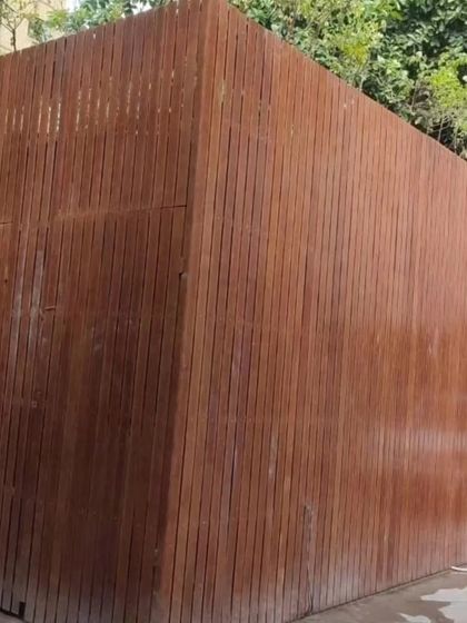 This solid wall is clad entirely in our vertically installed Tipwood, creating a private and fortress-like enclosure. It's a great solution for service blocks or areas requiring complete visual screening.