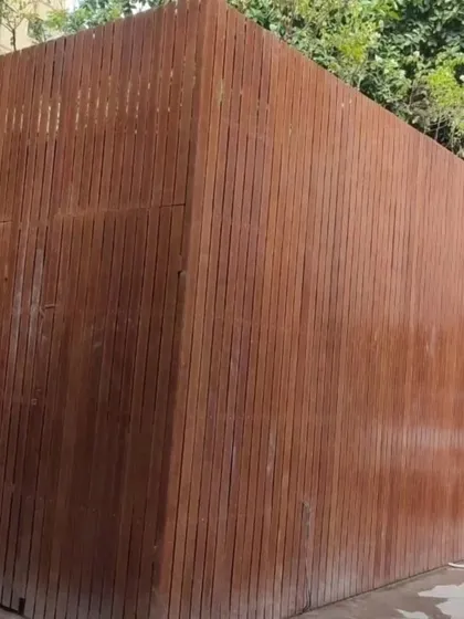 This solid wall is clad entirely in our vertically installed Tipwood, creating a private and fortress-like enclosure. It's a great solution for service blocks or areas requiring complete visual screening.