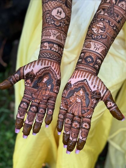 A close-up of the palms from the royal-themed bridal mehendi, showing the detailed portraits.