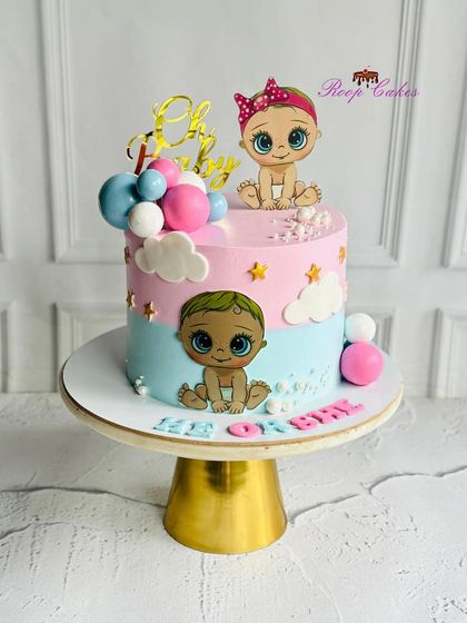 He or She, what will the baby be? This cute gender reveal cake features pink and blue sections with adorable baby toppers, building anticipation for the happy news.