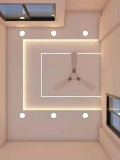 A false ceiling can be both beautiful and practical. This minimalist design seamlessly integrates a ceiling fan within a clean, rectangular frame, using subtle cove lighting and spotlights to maintain a modern and uncluttered look.