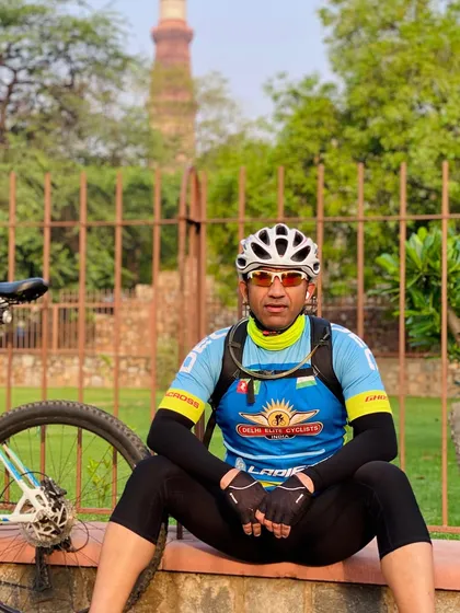 Our captain taking a rest with Qutub Minar visible in the distance. A perfect blend of fitness and heritage.