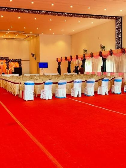 This image shows a wide view of a large reception hall we decorated. We handled the main stage decoration as well as the hall draping and guest seating arrangements, ensuring a cohesive look throughout the entire venue.
