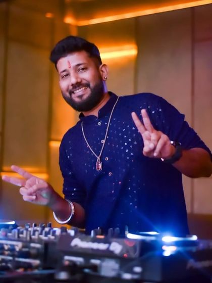 Peace and positivity from the DJ booth. Dressed in a traditional blue kurta for a festive vibe.