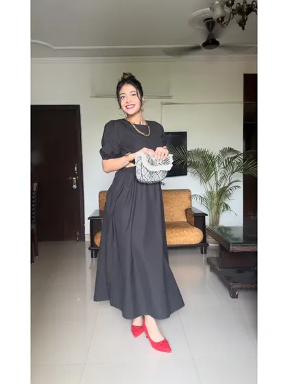 A classic black dress with a modern twist. The side cutouts add a hint of allure, while the red shoes provide a perfect pop of color.