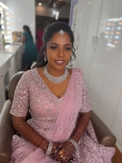 A smiling portrait of Surya in the studio. Her makeup is flawless, and she looks absolutely ready for her reception celebration.