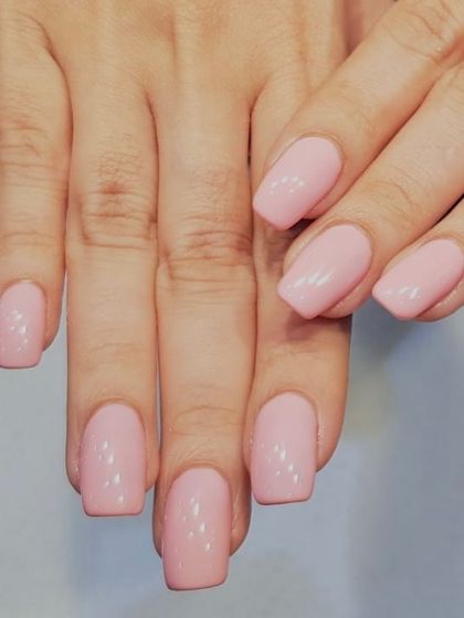 A cute and chic baby pink gel manicure. This classic color looks beautiful on these medium-length, coffin-shaped nails.