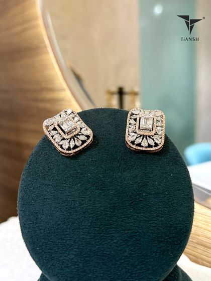 Paired with the multi strand choker, these square cut earrings frame a delicate floral dance in rose gold. They are bold, balanced, and beautifully unexpected.