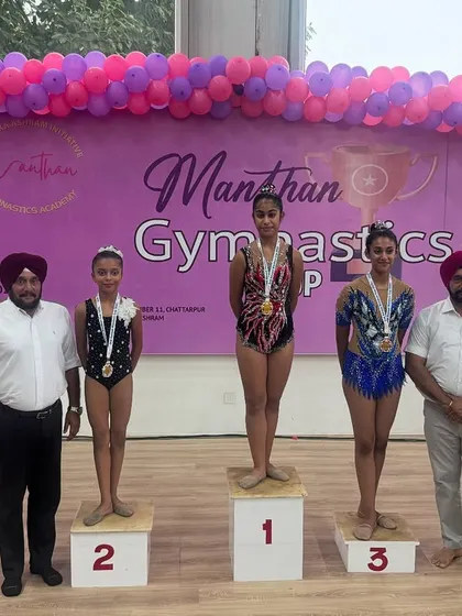 Standing proud on the winner's podium. We coach our gymnasts not just to perform, but to win, and moments like these at the Manthan Gymnastics Cup are what it's all about.