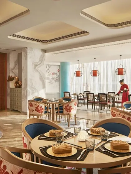A wider view of the Oriental Pavilion, showing the spacious layout and harmonious blend of colors and patterns. The design creates a cohesive and immersive dining experience inspired by Asian aesthetics.