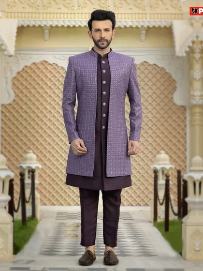 For a look that is both royal and modern, I recommend a Jodhpuri suit like this one. This particular piece features a textured purple bandhgala jacket over a matching dark kurta and trousers, creating a sharp, layered silhouette perfect for a reception or sangeet.