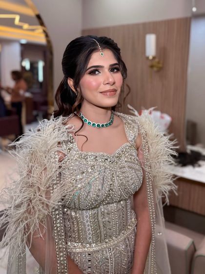 Soft glam with a touch of drama. The feathered outfit is the star, so we kept the makeup soft, glowy, and beautiful.