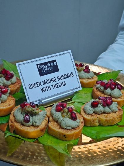 Green Moong Hummus with Thecha on toast, topped with pomegranate seeds. This is a unique fusion appetizer that combines Middle Eastern and Maharashtrian flavours.