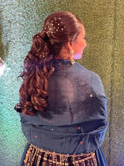 A still shot of the pearl-sparkled ponytail, showing the delicate placement of the pearls for a starry-night effect.