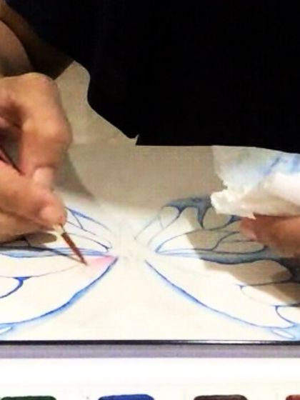 A close-up of a student working on delicate butterfly wings with watercolors. Our classes focus on building skills step-by-step, so you can tackle detailed projects with confidence.