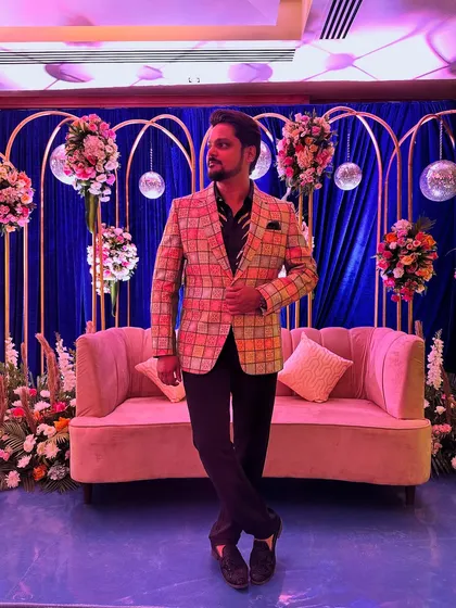 Posing by the beautiful decor before an event. My outfit is always chosen to complement the event's aesthetic and my role as the host.