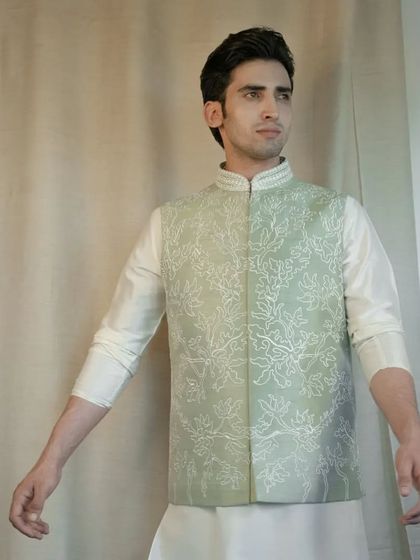 Radiate floral splendor with our captivating Pista Green Silk Jacket. The intricate floral dori work creates an unforgettable fashion statement.