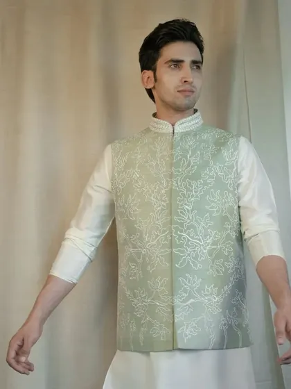 Radiate floral splendor with our captivating Pista Green Silk Jacket. The intricate floral dori work creates an unforgettable fashion statement.