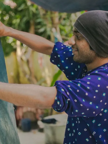 A happy participant at one of our workshops, inspecting his freshly dyed fabric. Our hands-on sessions are all about having fun and learning together.