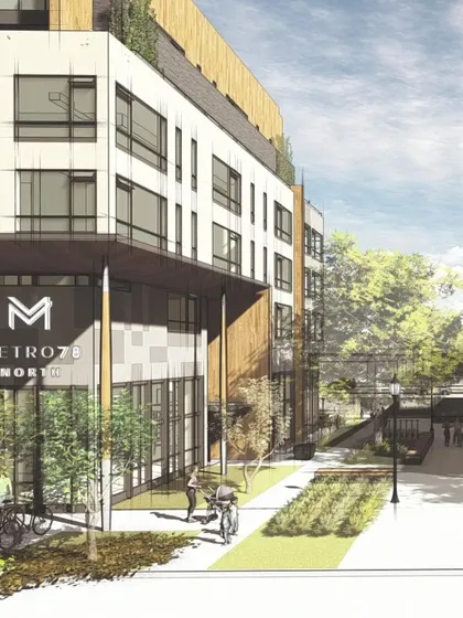 A render of the Metro 78 North building, showcasing its integration with the public realm. The design includes wide sidewalks and space for bicycles, reflecting its car-free ethos and its role in creating a pedestrian-friendly environment around the LRT station.