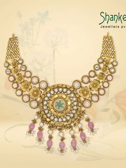 A majestic Kundan-style necklace with a large circular pendant, featuring pink beads and pearls. This piece is a perfect example of our grand, contemporary-traditional fusion designs.