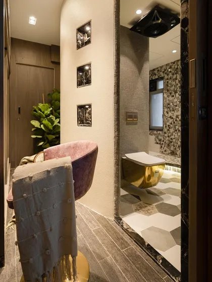 The walk-in closet and restroom area are designed to be intriguing spaces. This view shows the transition from the dressing area to the luxurious toilet, which features a statement golden commode.