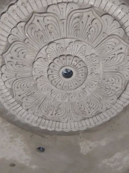 A finished floral medallion for a ceiling. This is a beautiful way to decorate the area around a fan or light fixture, drawing the eye upward.