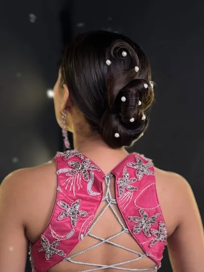 This angle shows how the hairstyle works with the model's outfit. I teach my students to always consider the neckline and style of the dress when creating an updo for a client.