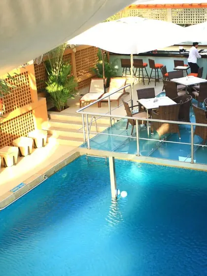Our pool is more than just a place to swim; it's a premium social space. This view shows our poolside lounge area where members can relax, connect, and unwind, making it a true lifestyle destination.