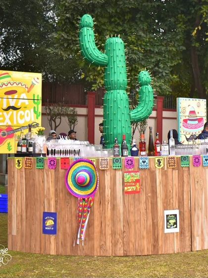 The 'Viva Mexico' bar was built from wood and decorated with a giant cactus, a sombrero, and colorful banners to create a lively service area.