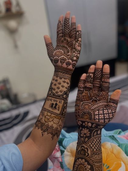 Both hands together, showing the complete personalized bridal mehandi. One arm tells the story with the date, while the other features a dense, traditional pattern for a beautiful contrast.