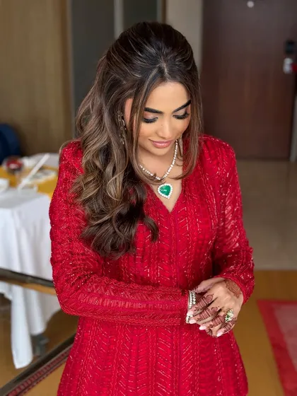 A quiet, posed moment showing the intricate details of her red outfit.