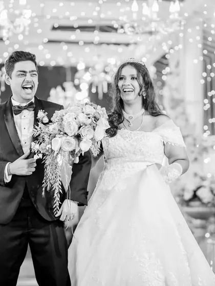 The grand entrance is a moment of pure joy and excitement. I capture this energy in a candid style, focusing on the couple's genuine laughter and happiness as they are welcomed by their loved ones.