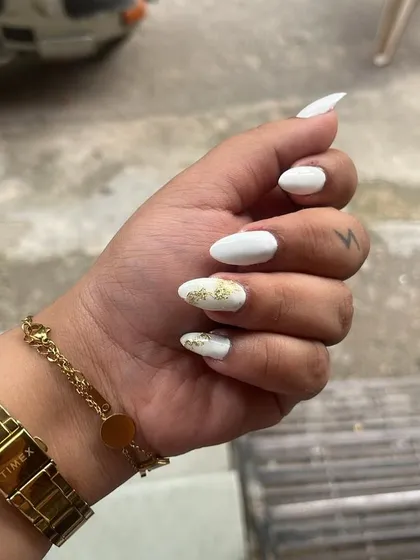 A chic and simple design on natural nails. A crisp white polish with a single accent nail featuring gold foil.
