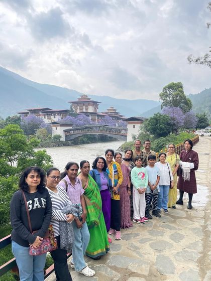 A group photo from our recent Bhutan trip, with the stunning Punakha Dzong fortress in the background. You can see the beautiful jacaranda flowers in bloom, which you find in Bhutan during the spring season.