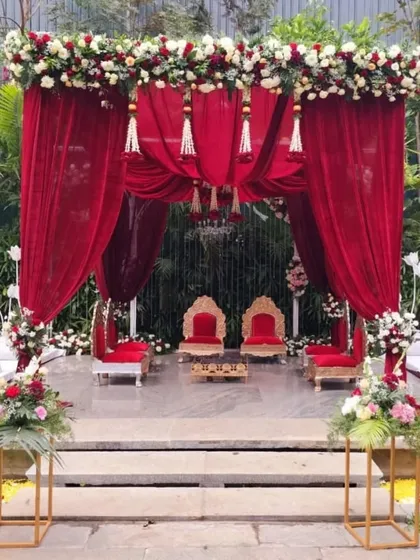 For a classic and regal wedding, we designed this stunning mandap with rich, red velvet draping. The look is completed with traditional floral tassels and ornate seating, creating a timeless and opulent setting for the main ceremony.