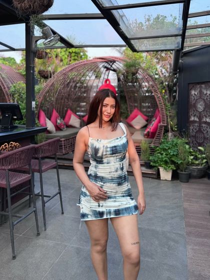 Posing in the eye-catching printed dress.