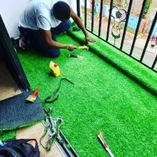 Here you can see my team at work installing a 25mm artificial grass roll on a residential balcony. I handle the entire process, ensuring a clean fit and finish with no mess.