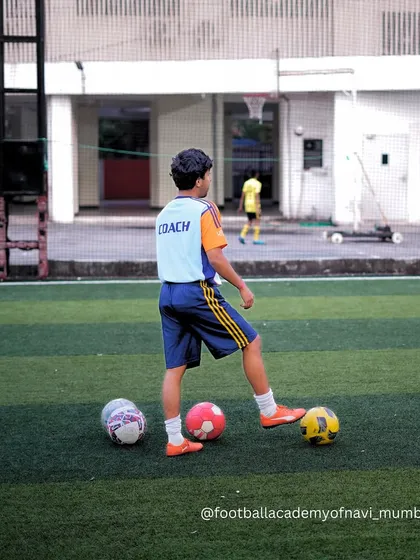 A young coach-in-training observes the session, learning the game from a different perspective.