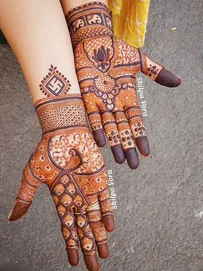A classic design combining a graceful peacock on one hand with a lotus and swastika motif on the other, perfect for any festive occasion.