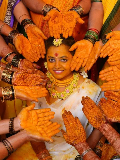 The vibrant colors of a Haldi ceremony beautifully complementing the rich stain of our henna. This photo captures the joy and tradition of a wedding, where our mehendi plays a special part.