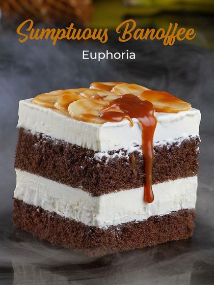 My Sumptuous Banoffee Euphoria ice cream cake. It features layers of chocolate sponge and banana cream, topped with fresh banana slices and a generous drizzle of rich caramel sauce.
