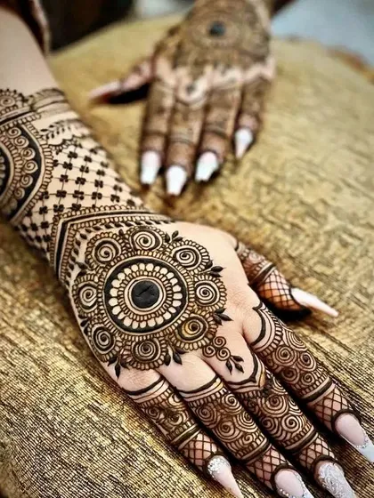 A classic mandala design on the back of the hand is always a showstopper. It’s a timeless choice that looks gorgeous with both Indian and Western outfits.