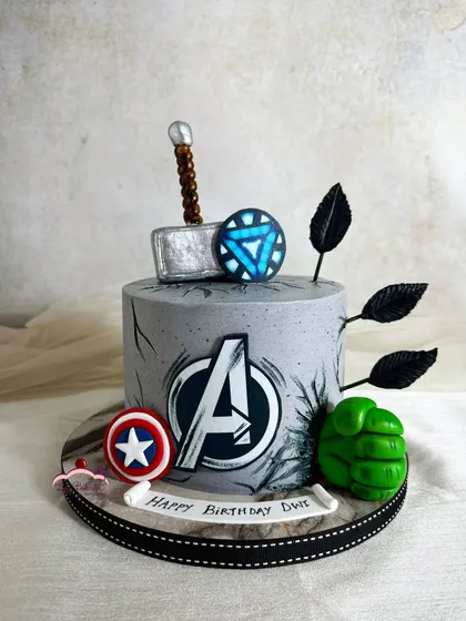 I assembled the mightiest heroes for this Avengers-themed birthday cake. It features Thor's hammer, Captain America's shield, Hulk's fist, and Iron Man's arc reactor, all handcrafted from sugar.
