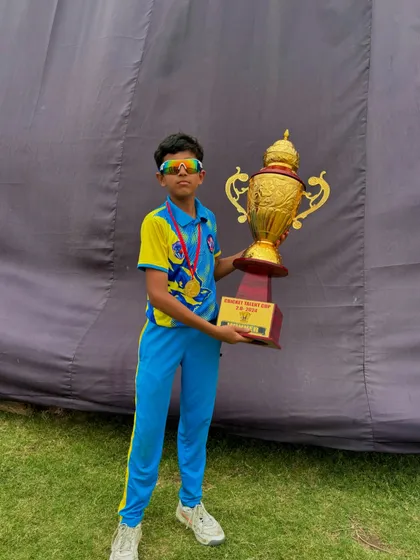 A stylish pose with the trophy. Confidence of a champion.