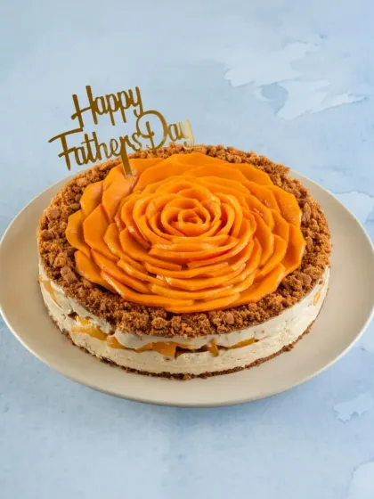 A full view of the Dad's Mango Biscoff Cheesecake. The combination of mango and Biscoff is a unique and delightful treat for Father's Day.