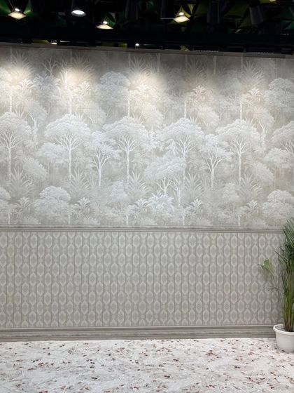 A full-wall tile mural depicting a serene forest landscape. This is an excellent alternative to wallpaper in bathrooms or living areas, offering the same beauty with superior durability.