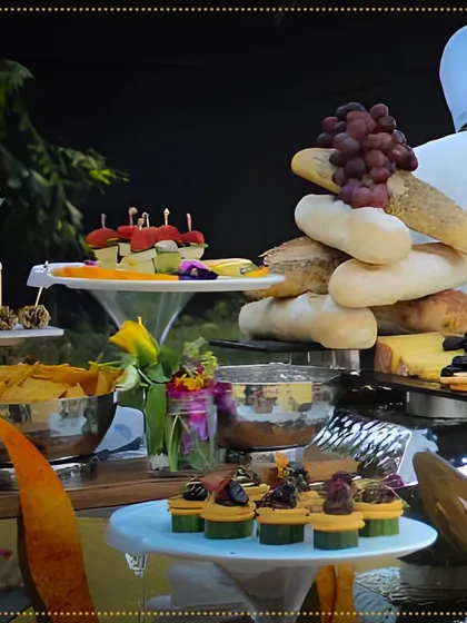 Get ready for a delectable taste from around the world. This grazing table features a tower of fresh bread, cheeses, fruits, and a variety of our signature canapés.
